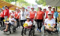 People walk for AO victims, disabled people