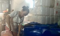 Vietnamese woman makes cleaning fluid from garbage