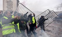 Paris police fire tear gas as yellow vest protests turn violent