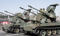 Japan’s ruling coalition approves new rules on arms exports