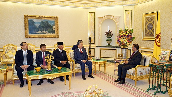 Polizeiminister To Lam begrüßt Bruneis Sultan Hassanal Bolkiah