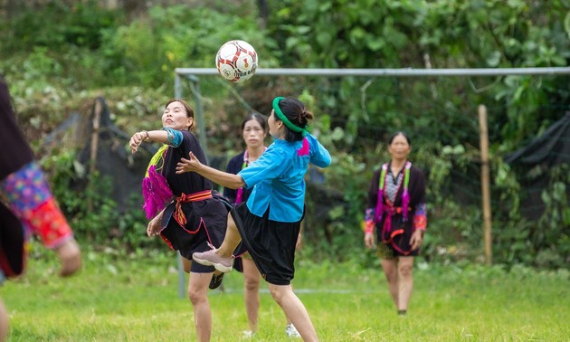 Ethnic women play football in skirts in mountainous market