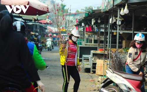 Bustling flower market ahead of Lunar New Year holiday - ảnh 9