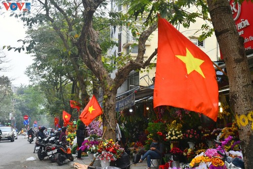 กรุงฮานอยเต็มสีสันของธงชาติและดอกไม้เพื่อฉลองการประชุมสมัชชาใหญ่พรรคคอมมิวนิสต์เวียดนามสมัยที่ 13 - ảnh 1