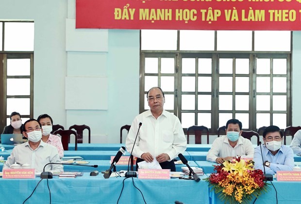 Presiden Nguyen Xuan Phuc Lakukan Sidang Kerja dengan Pimpinan Teras Kabupaten Cu Chi dan Kabupaten Hoc Mon, Kota Ho Chi Minh - ảnh 1