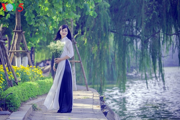 Les Vietnamiennes s’habillent en ao dài pour la fête du Têt - ảnh 9