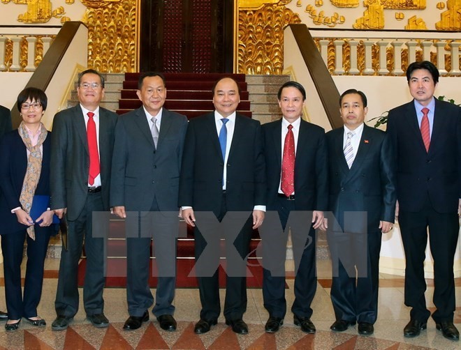 PM asks Vietnamese, Lao news agencies to foster links  - ảnh 1