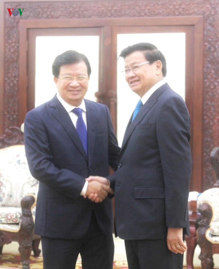 Deputi PM Trinh Dinh Dung melakukan pertemuan dengan PM dan Ketua Parlemen Laos - ảnh 1