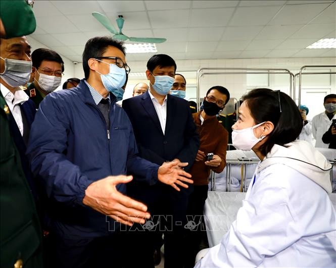 Deputy PM visits first three volunteers injected with COVID-19 vaccine  - ảnh 1