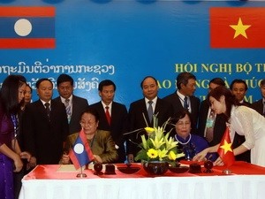 เวียดนาม-ลาวลงนามบันทึกการประชุมรัฐมนตรีว่าการกระทรวงแรงงานและสวัสดิการสังคมครั้งที่๓   - ảnh 1