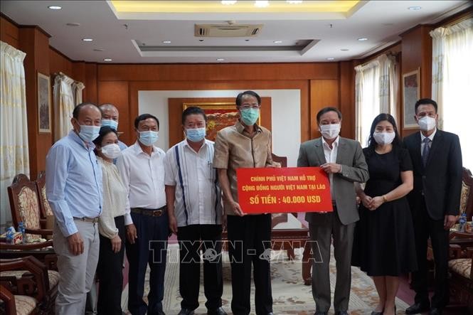 ให้การช่วยเหลือชาวเวียดนามในประเทศลาวเพื่อต่อสู้กับการแพร่ระบาดของโรคโควิด-19 - ảnh 1