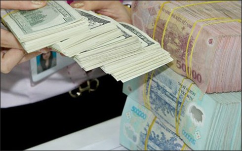 ธนาคารชาติเวียดนามปรับอัตราแลกเปลี่ยนเงินดอลลาห์สหรัฐกับเงินด่ง - ảnh 1